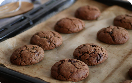 Cookies à la farine de drêche brune sur une plaque de cuisson sortant du four